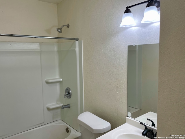 full bathroom with bathing tub / shower combination, sink, and toilet