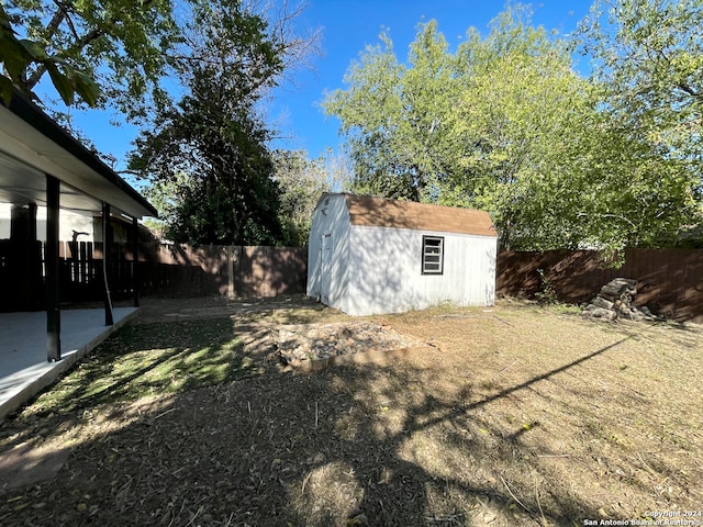 view of yard featuring a patio area and a storage shed