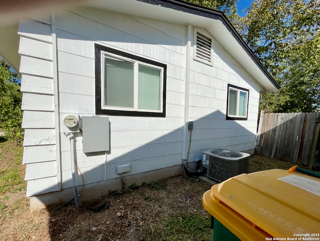 view of side of property with central air condition unit