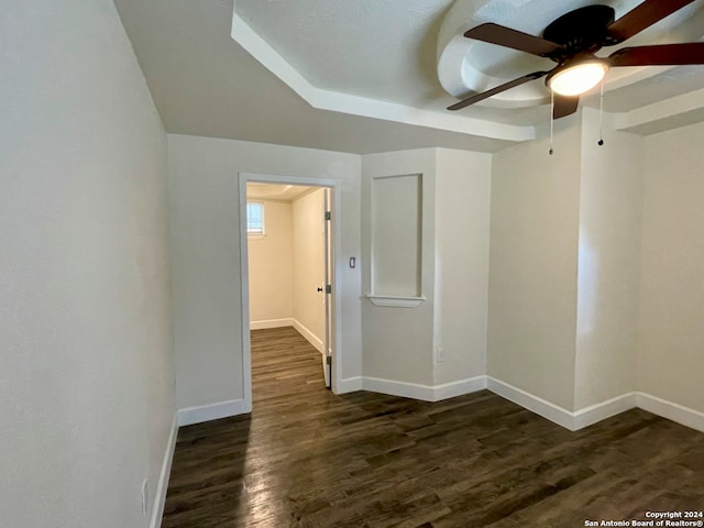 empty room featuring ceiling fan and dark wood-type flooring