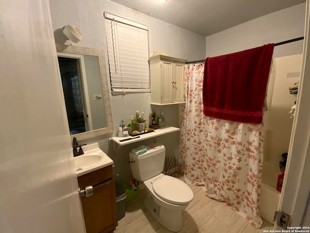 full bathroom with vanity, shower / bath combo, and toilet