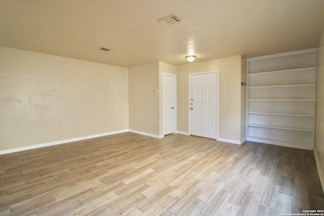 spare room with light wood-type flooring