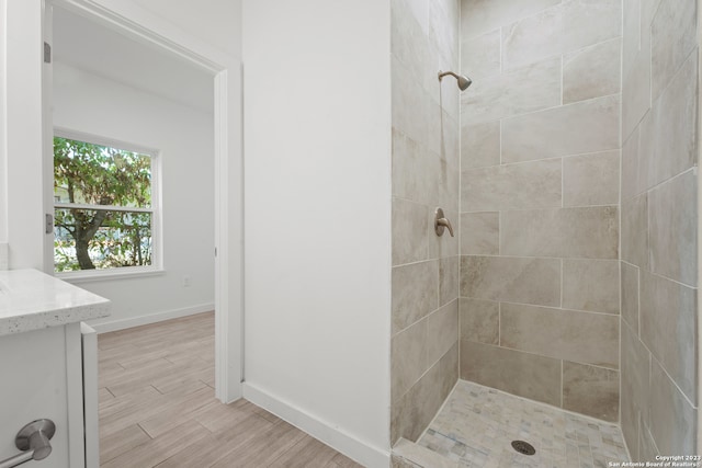 bathroom featuring vanity and tiled shower