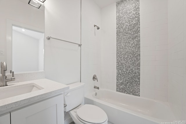 full bathroom with vanity, tiled shower / bath, and toilet