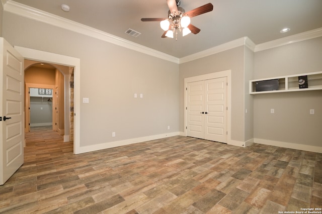 unfurnished bedroom with a closet, ceiling fan, hardwood / wood-style floors, and ornamental molding