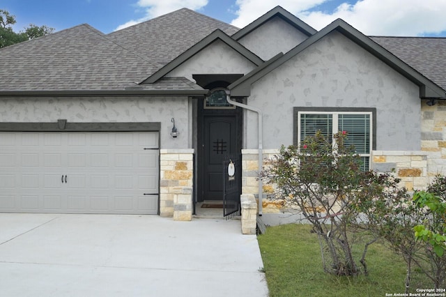 2407 Fm 1283, Pipe Creek, TX 78063 - french provincial home with stone siding, roof with shingles, driveway, and a garage