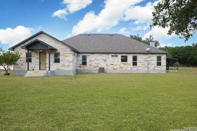 2407 Fm 1283, Pipe Creek, TX 78063 - back of property with stone siding, a chimney, a yard, and a shingled roof