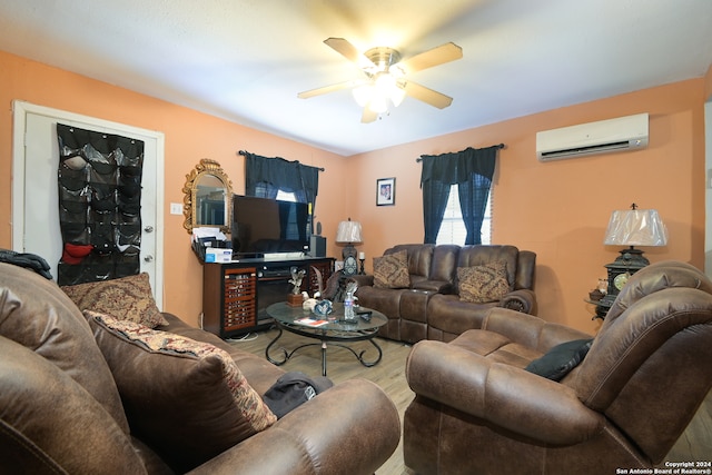 living room featuring hardwood / wood-style floors, a wall unit AC, and ceiling fan