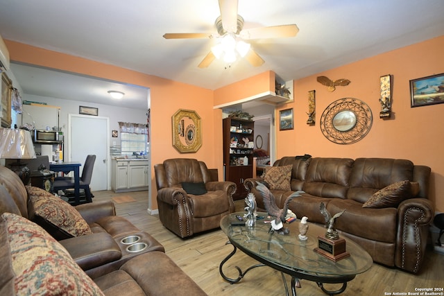 living room featuring ceiling fan and light hardwood / wood-style floors