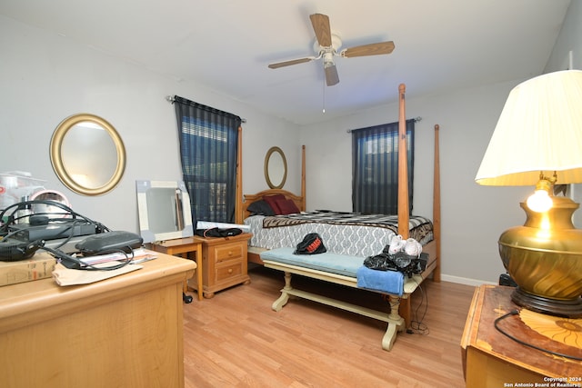 bedroom with light hardwood / wood-style floors and ceiling fan