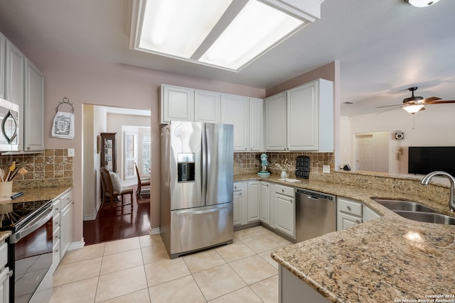 kitchen with white cabinets, a wealth of natural light, sink, and appliances with stainless steel finishes