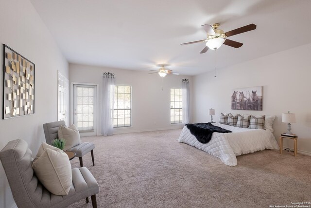 carpeted bedroom with ceiling fan and baseboards