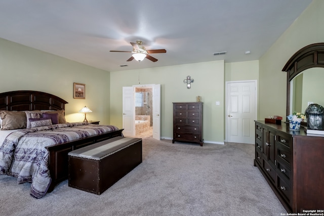 bedroom with ensuite bath, ceiling fan, and light carpet