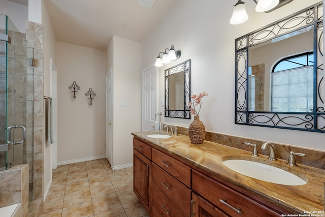 bathroom featuring tile patterned floors, vanity, and a shower with shower door