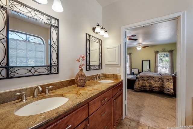 bathroom with tile patterned flooring, plenty of natural light, ceiling fan, and vanity