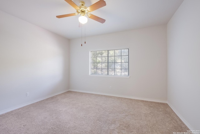carpeted empty room featuring baseboards and ceiling fan