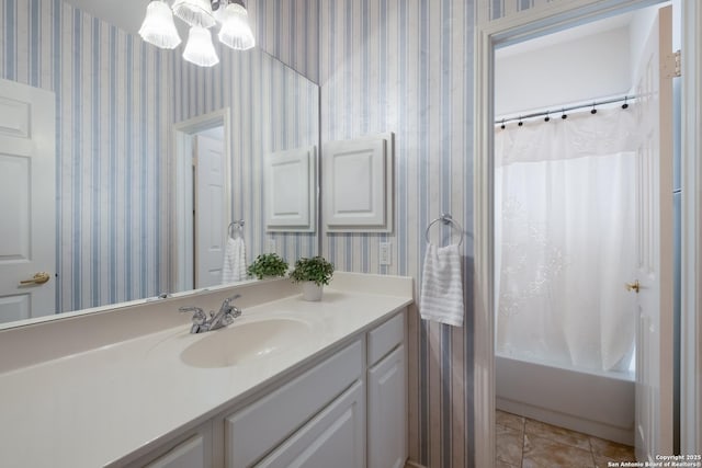 full bathroom with vanity, a chandelier, wallpapered walls, and shower / tub combo
