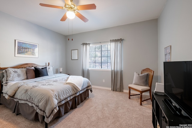 bedroom with ceiling fan and light colored carpet