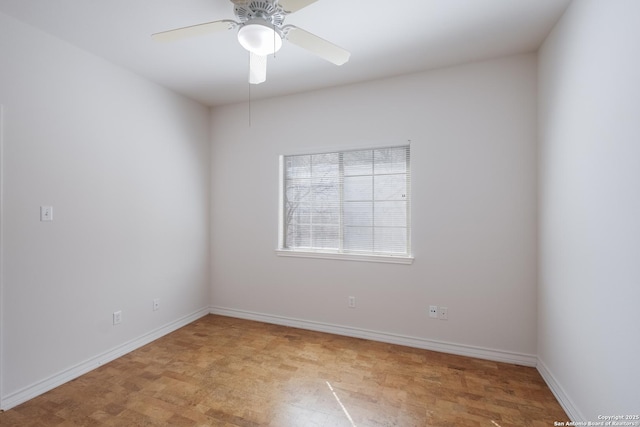spare room with light wood-style floors, baseboards, and ceiling fan