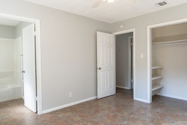 unfurnished bedroom featuring ceiling fan and a textured ceiling