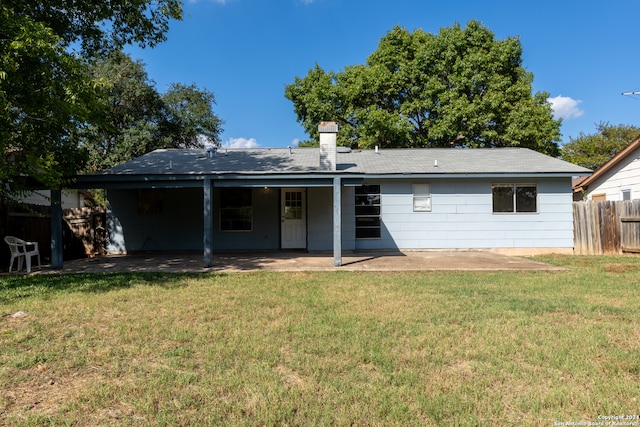 rear view of house featuring a patio area and a yard