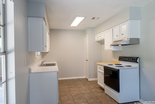 kitchen with white cabinetry, electric range, sink, and a textured ceiling