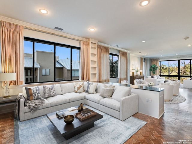 living room with dark parquet floors, a healthy amount of sunlight, and crown molding