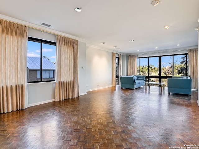 unfurnished living room featuring dark parquet floors, a wealth of natural light, and crown molding