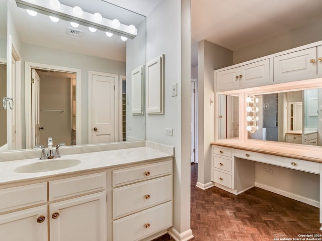 bathroom with vanity and parquet floors