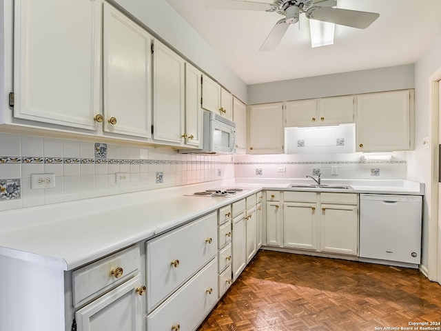 kitchen with dark parquet flooring, white appliances, sink, ceiling fan, and white cabinetry