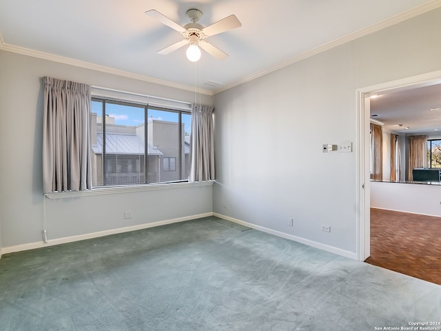 spare room featuring carpet flooring, ceiling fan, and crown molding