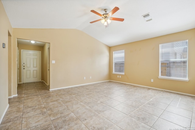 unfurnished room featuring a wealth of natural light, light tile patterned floors, ceiling fan, and lofted ceiling