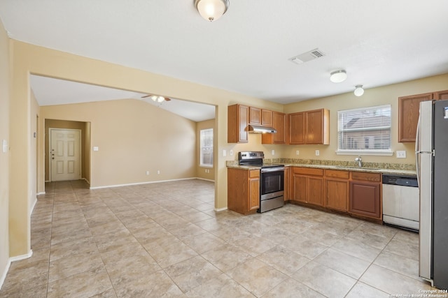 kitchen with stainless steel appliances, ceiling fan, sink, light tile patterned floors, and lofted ceiling