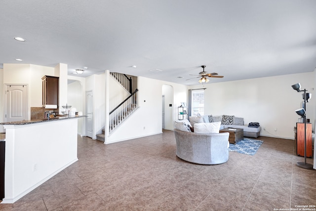 tiled living room with ceiling fan