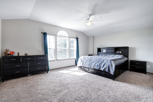 bedroom with carpet floors, vaulted ceiling, and ceiling fan