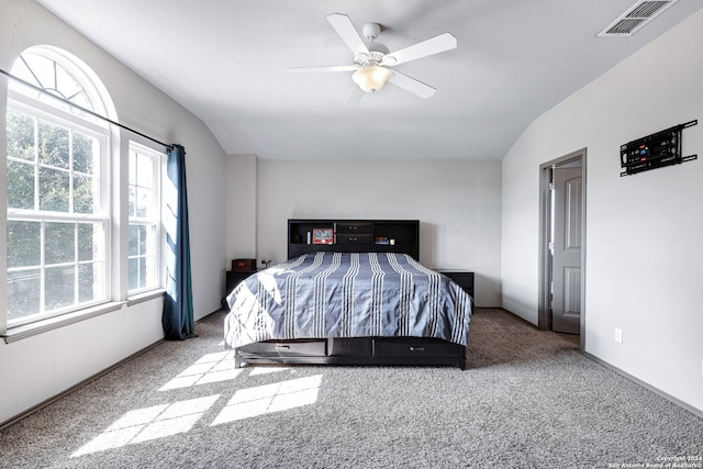 bedroom featuring ceiling fan, lofted ceiling, and carpet floors