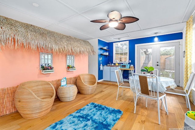 dining space featuring ceiling fan, hardwood / wood-style floors, and french doors