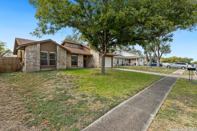 ranch-style house with a garage and a front lawn