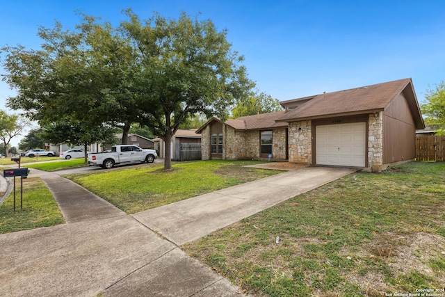 ranch-style house featuring a front lawn and a garage