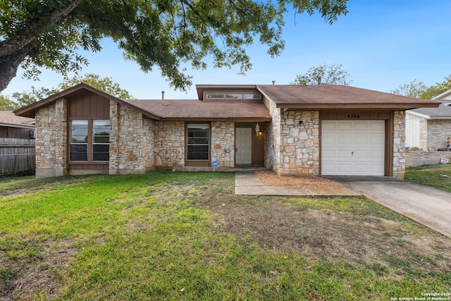 ranch-style home with a front yard and a garage