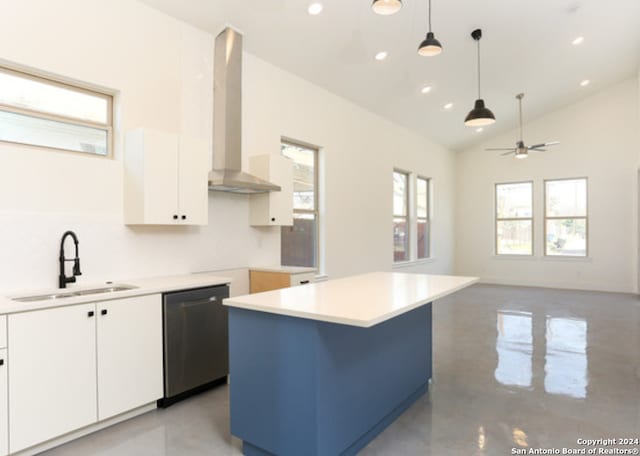 kitchen with stainless steel dishwasher, vaulted ceiling, a kitchen island, wall chimney range hood, and white cabinetry