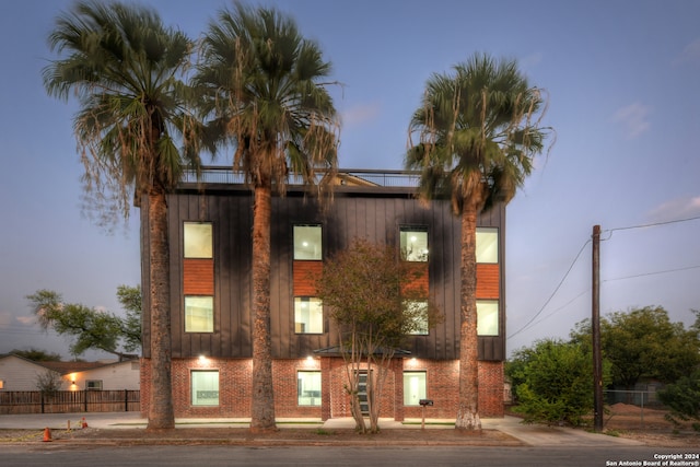 view of outdoor building at dusk