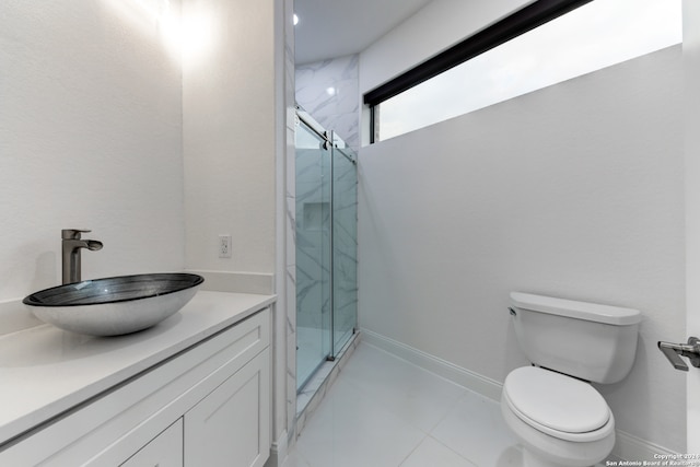 bathroom with vanity, toilet, and an enclosed shower