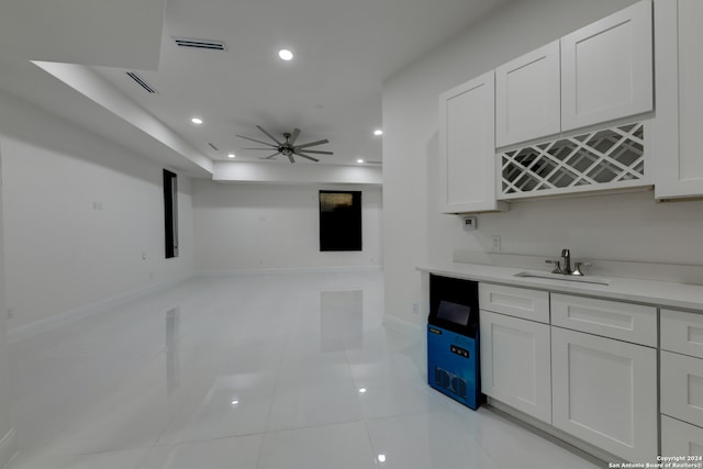 bar with white cabinetry, sink, ceiling fan, and light tile patterned flooring