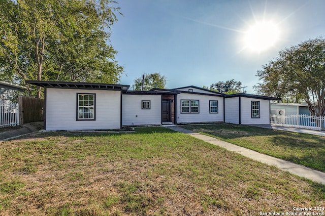 ranch-style home with a front lawn