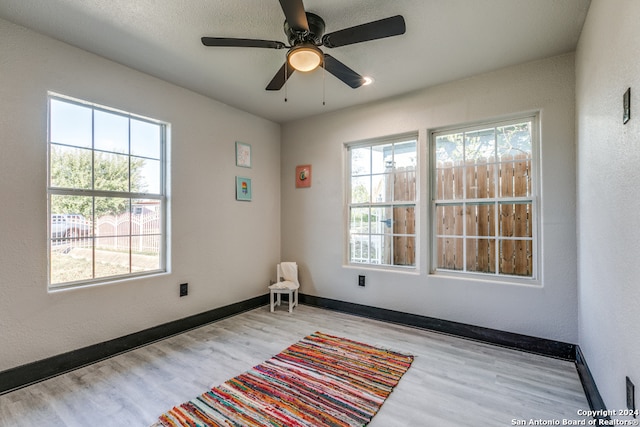 unfurnished room with light hardwood / wood-style flooring and ceiling fan