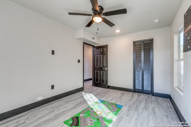 playroom with ceiling fan and light hardwood / wood-style floors