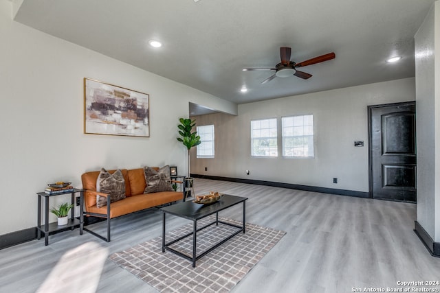 living room with ceiling fan and light hardwood / wood-style floors