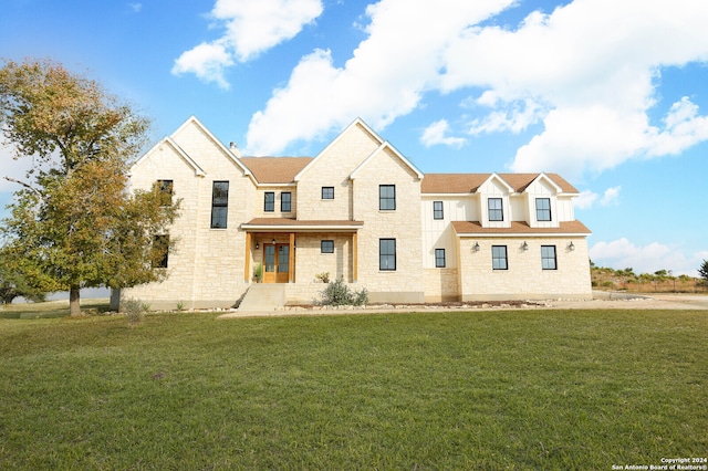 view of front of property with covered porch and a front lawn