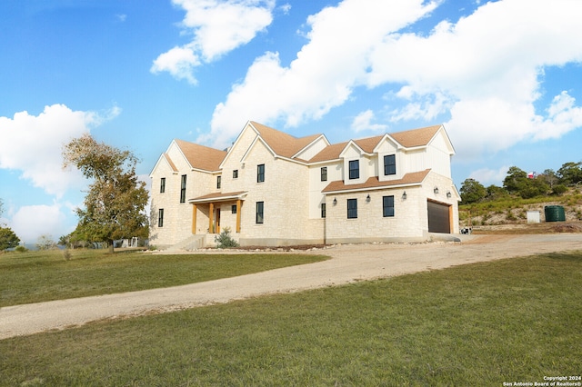 view of front of property featuring a garage and a front lawn